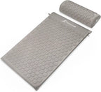Gray acupressure mat and pillow set on a white background