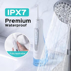 White dental water flosser with shower head and IPX7 waterproof label on a light gray background