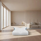 White pillow with blue accents on a wooden floor in a modern living room.