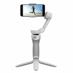 White smartphone gimbal with phone attached on a white background