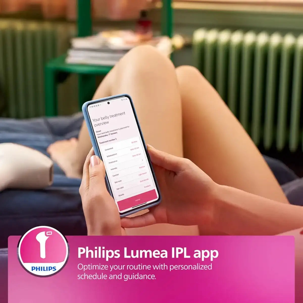 Person using a smartphone with the Philips Lumea IPL app on a blurred indoor background
