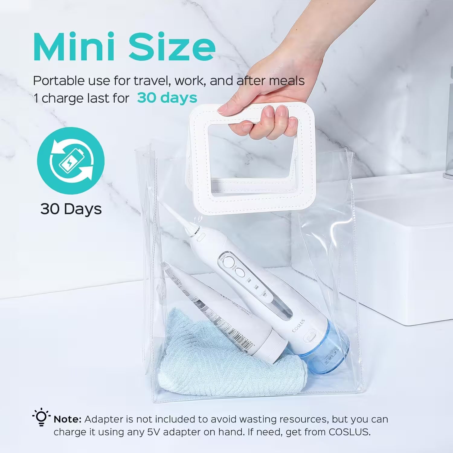 Portable electronic device with charging cable and cleaning brush, held by a hand, on a light gray background.