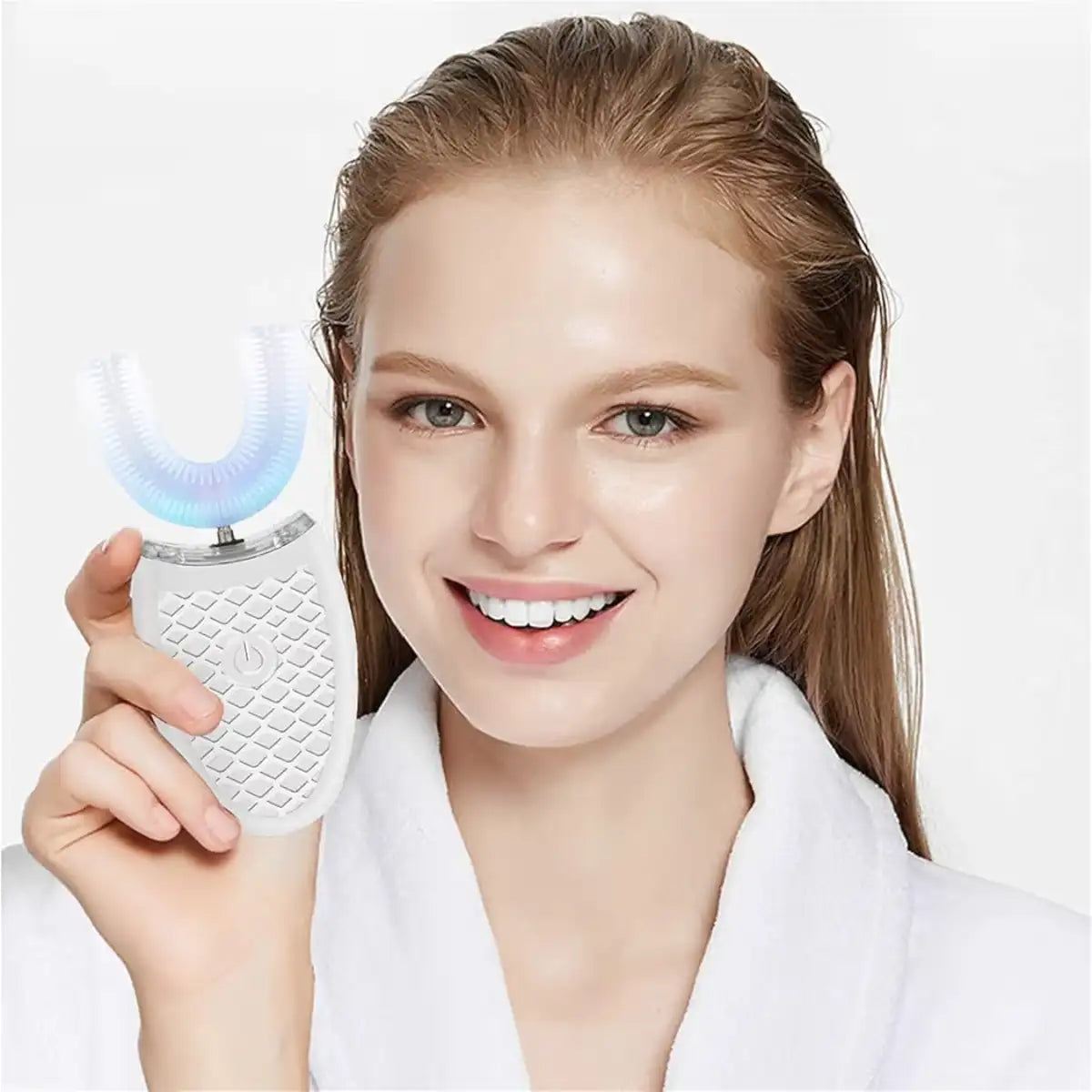 Woman holding a white electronic device with a blue light on a white background