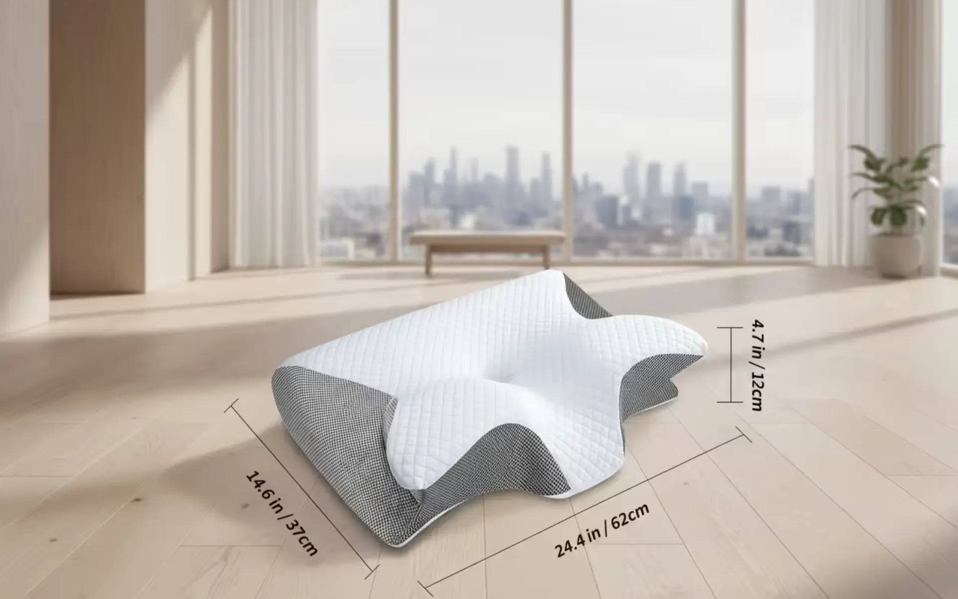 Ergonomic pillow with dimensions displayed on a wooden floor with a cityscape view.