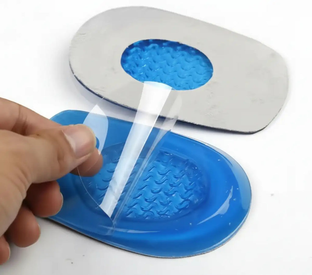Blue shoe inserts with a hand applying adhesive